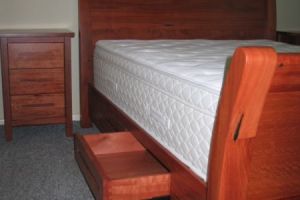 bedroomsettingmadefromredgumslaybedwithdrawerswithinrails.10